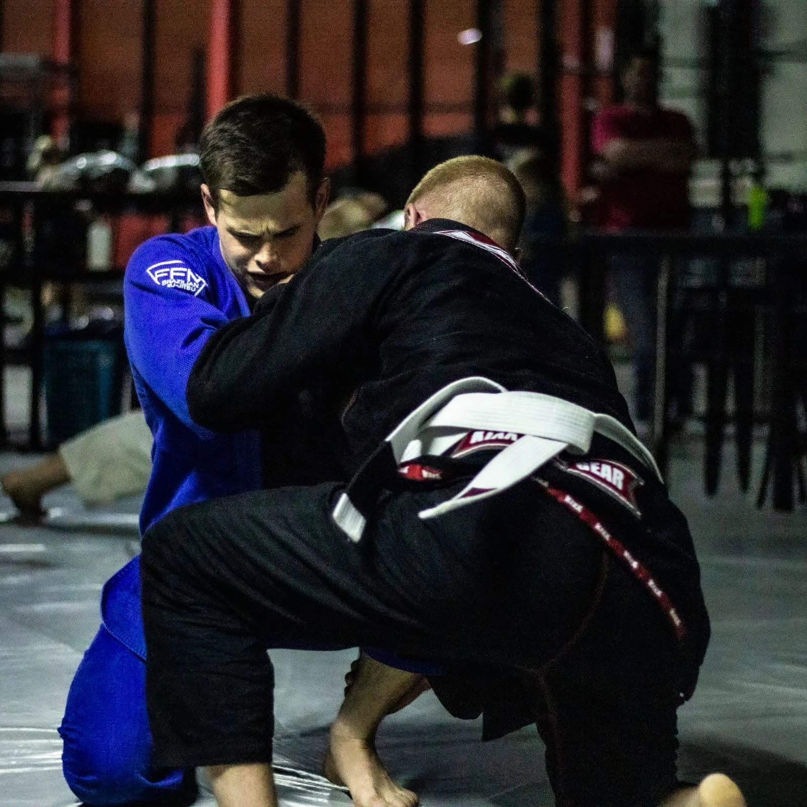 Two Brazilian Jiu-Jitsu students practising in blue and black gis