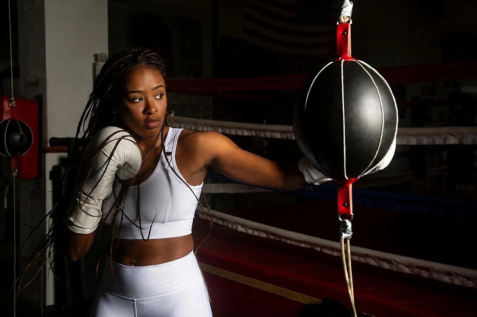 Woman boxing with a double-end bag in the gym
